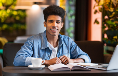 photo of boy at table with book