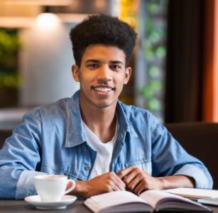 photo of boy at table with book