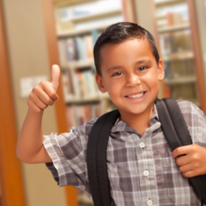 hispanic boy with backpack and thumbs up